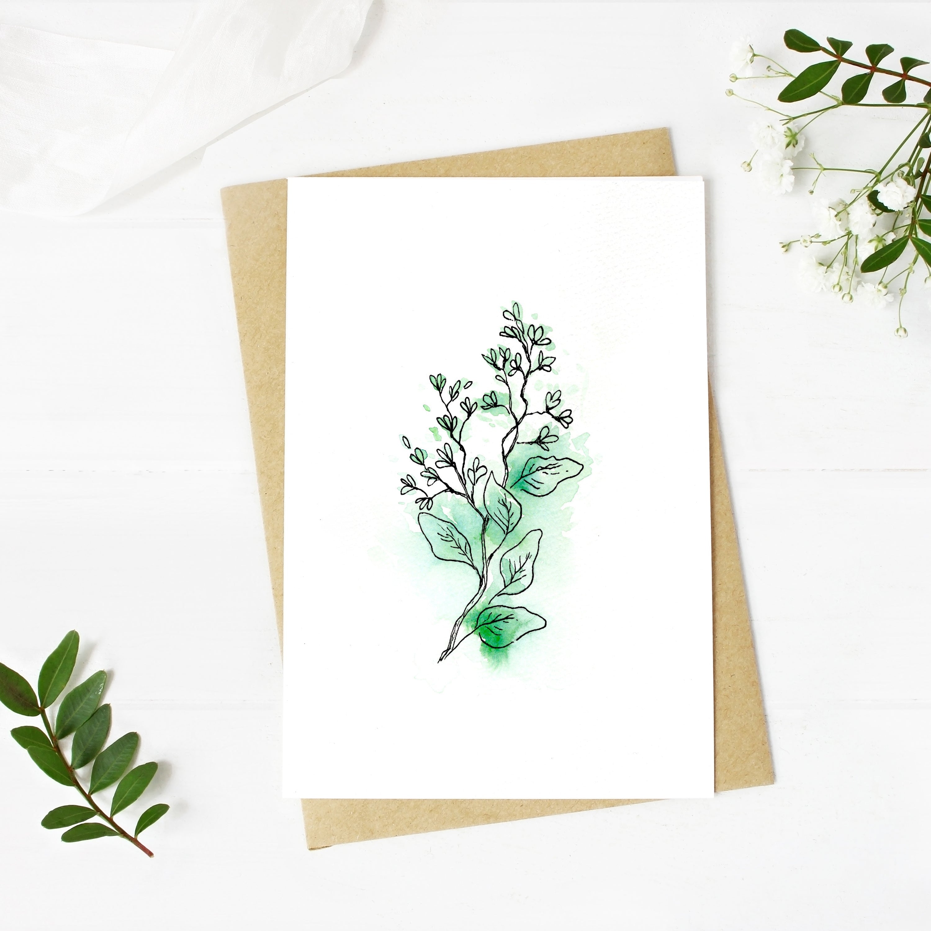 Greeting card with green leaf design on a white background