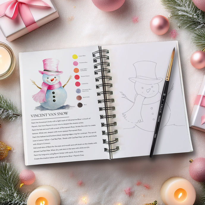 Open notebook with coloring book pages surrounded by Christmas decorations on a light surface.