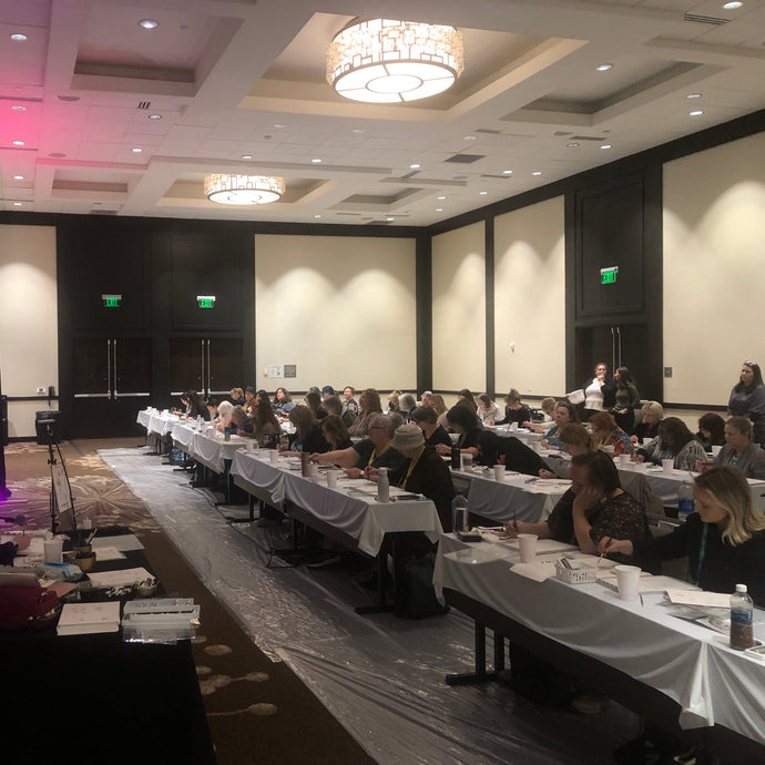 Conference room with long tables set up for a meeting or event.