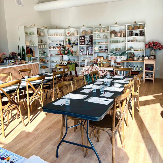 Dining area with wooden chairs and tables in a well-lit room.