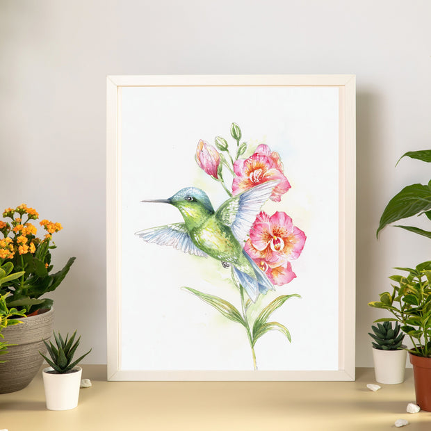 Hummingbird and Orchids painting in a beige frame surrounded by flowers for a Watercolor Painting Class