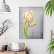 Decorative wall art of an ivory tulip in a home setting with a lamp and plants.