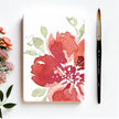 Floral notebook with flowers and a brush on a white background