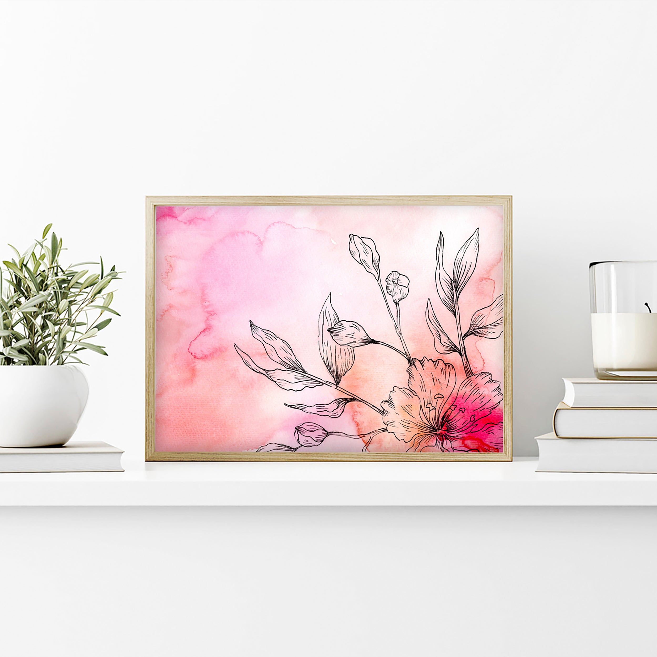 Framed floral artwork with pink watercolor background on a white shelf.