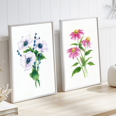 Two Flower Paintings Side by Side in a brightly lit room on a desk