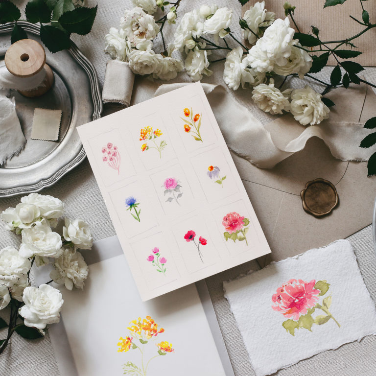 Moody wedding table mockup scene. Feminine desktop composition with fading white rose flowers, silver plate, silk ribbons, seal stamp, envelopes and blank greeting cards, grey background. flat lay,top